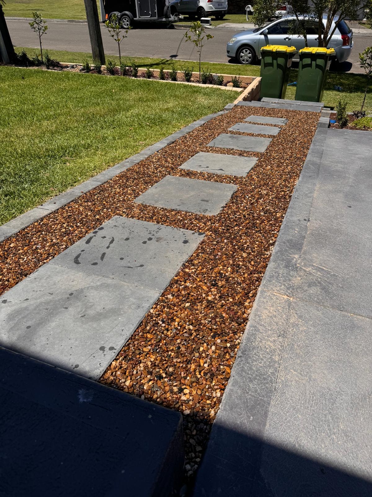 Bluestone stepping stone path through copper gravel with garden edging