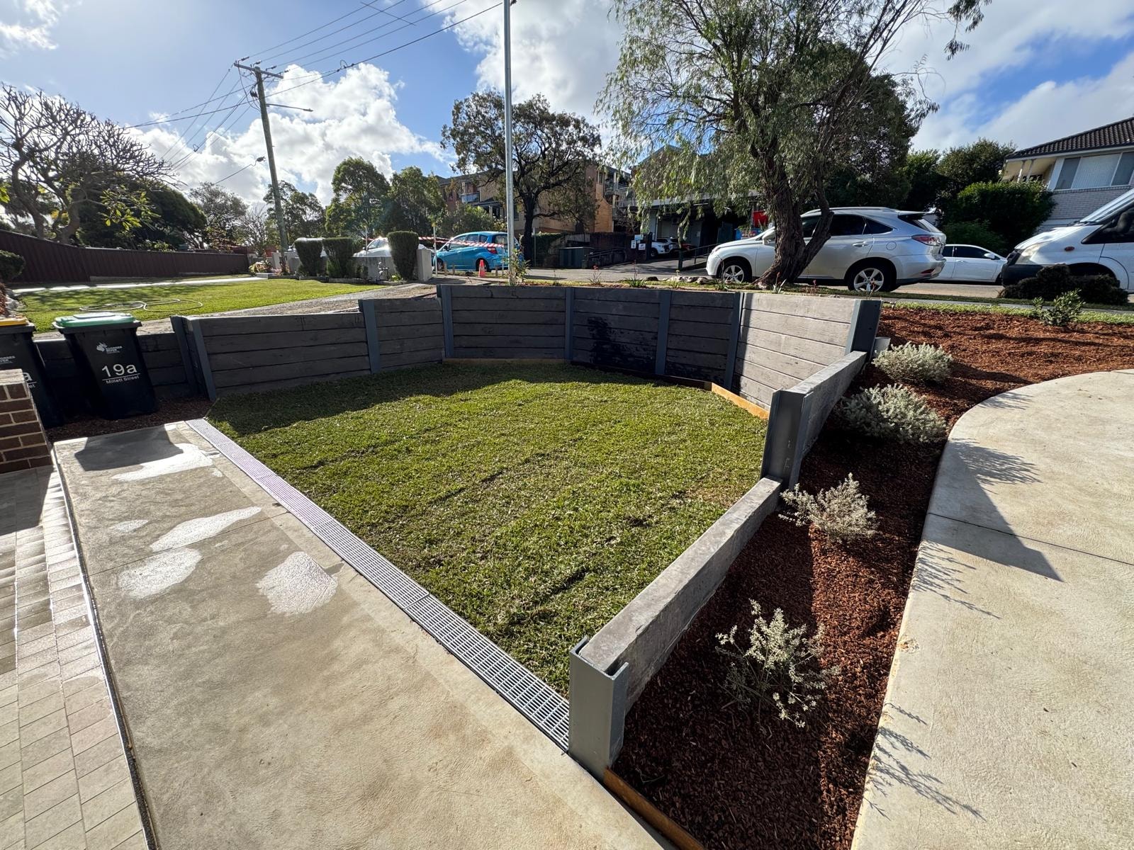 Front yard with concrete sleeper retaining wall, new lawn and garden beds