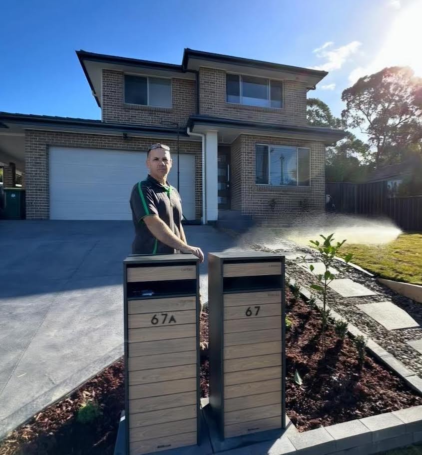 GPC Landscapes team member at completed driveway and garden project
