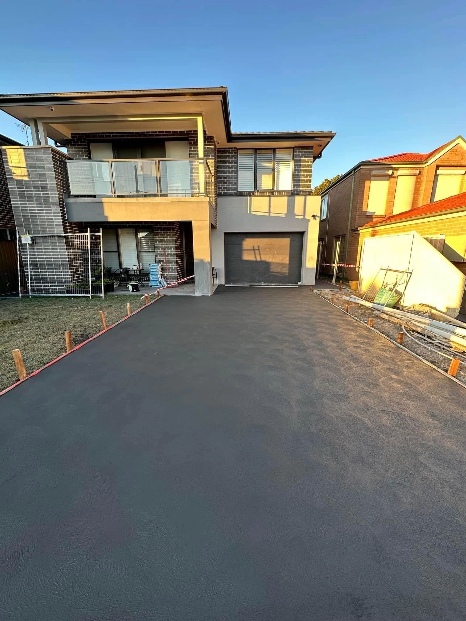 Sealed concrete driveway and pavers by GPC Landscapes